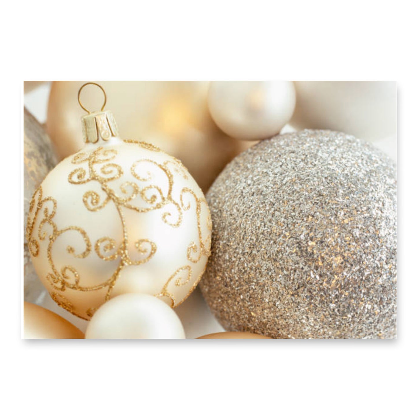 “Close-up of elegant gold and white Christmas ornaments with shimmering glitter and intricate swirl patterns.”