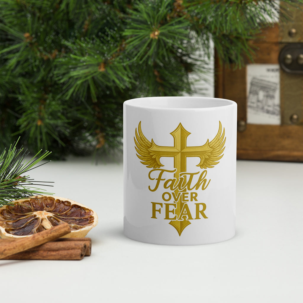 "Faith Over Fear mug with gold cross and wings design, featuring Christian symbolism and inspirational message."