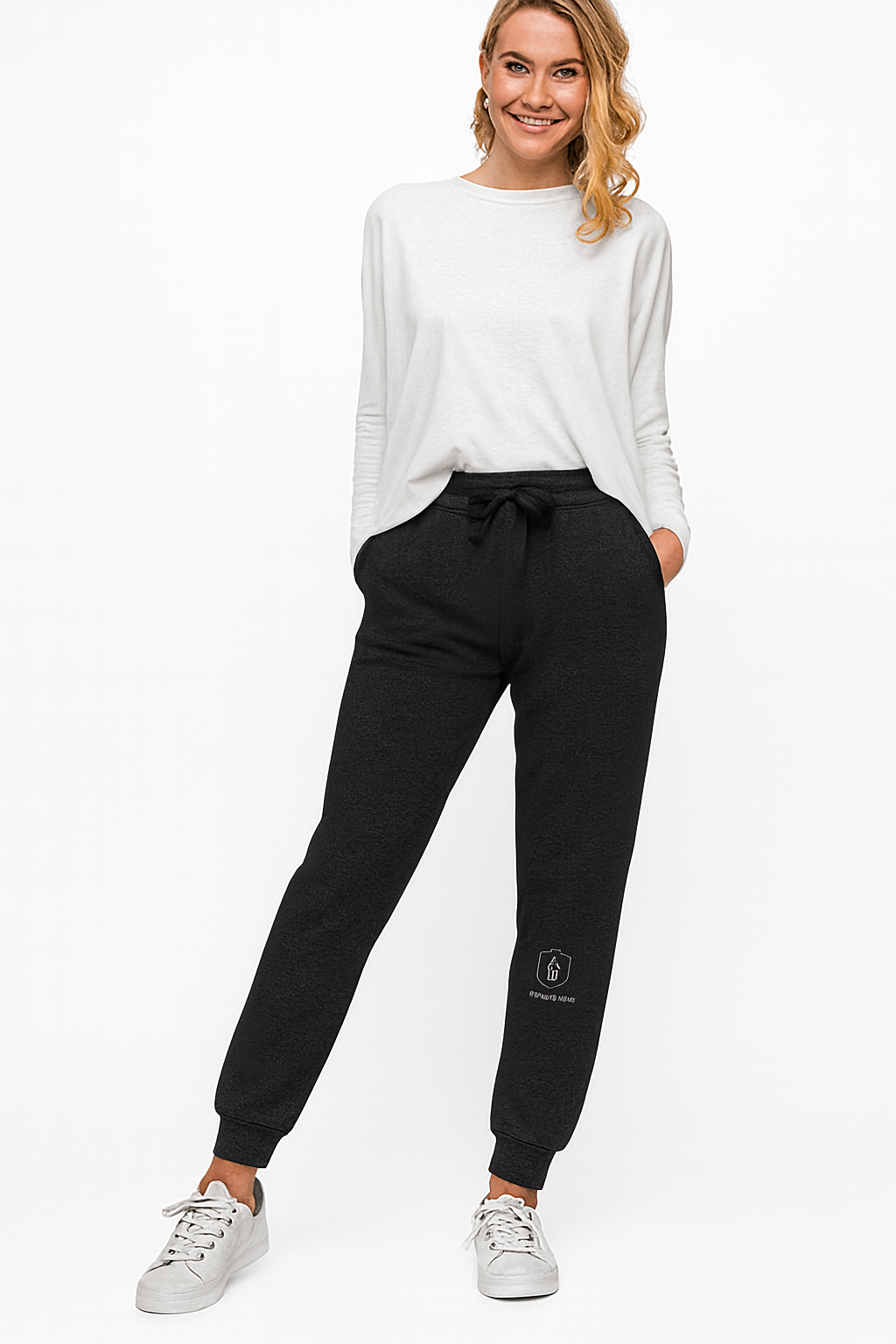 “Front view of black Gifted By God joggers with white embroidered shield and cross logo on lower leg, luxury Christian streetwear.”