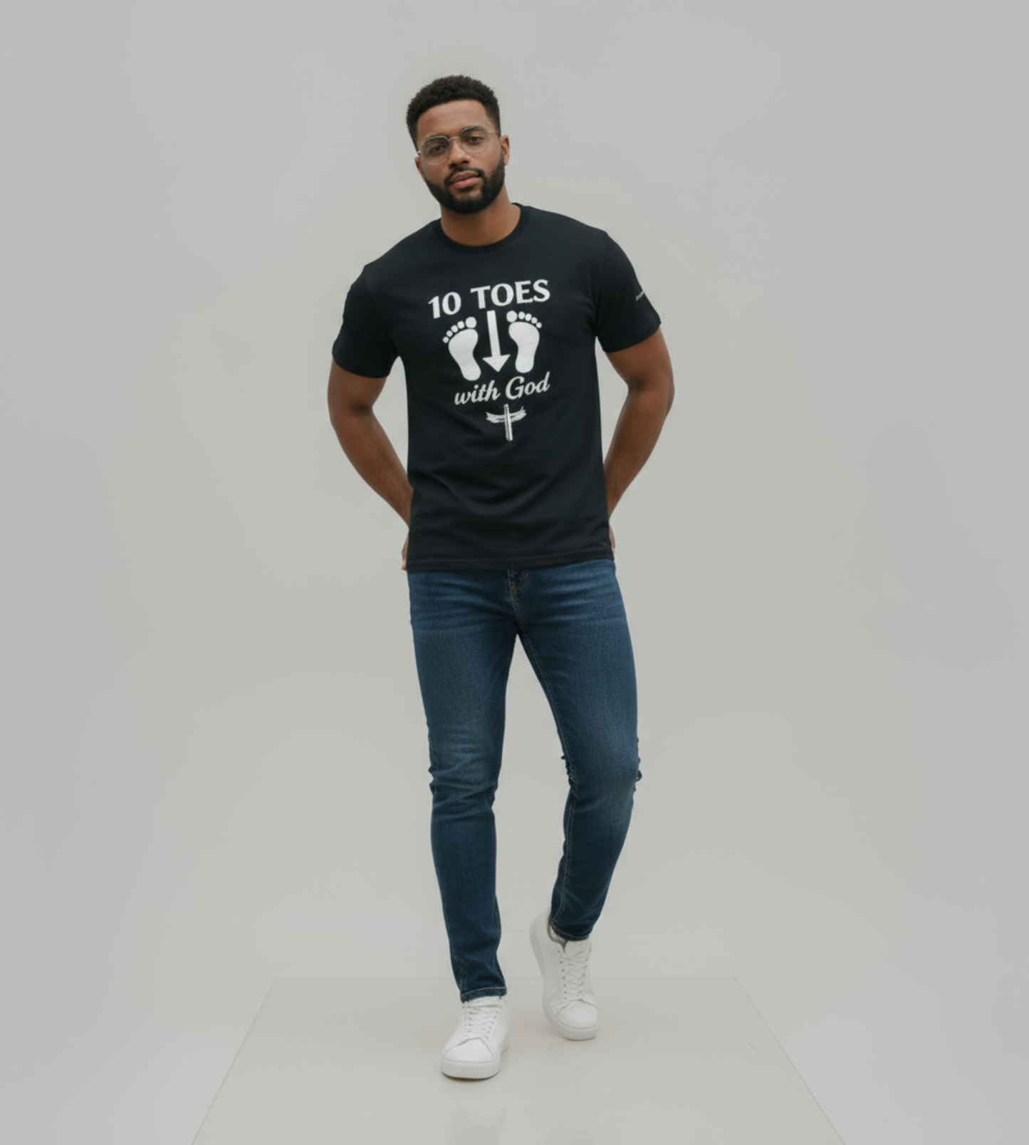 “Man wearing the 10 Toes Down With God black graphic tee, standing in a clean studio setting