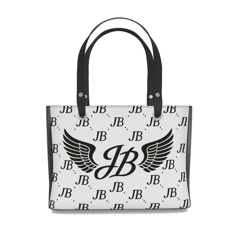 “Luxury white tote bag with sleek black handles, showcasing the bold JB wings logo centered on the front and an all-over repeating JB monogram pattern. A high-end fashion accessory designed for everyday elegance and exclusive style.”