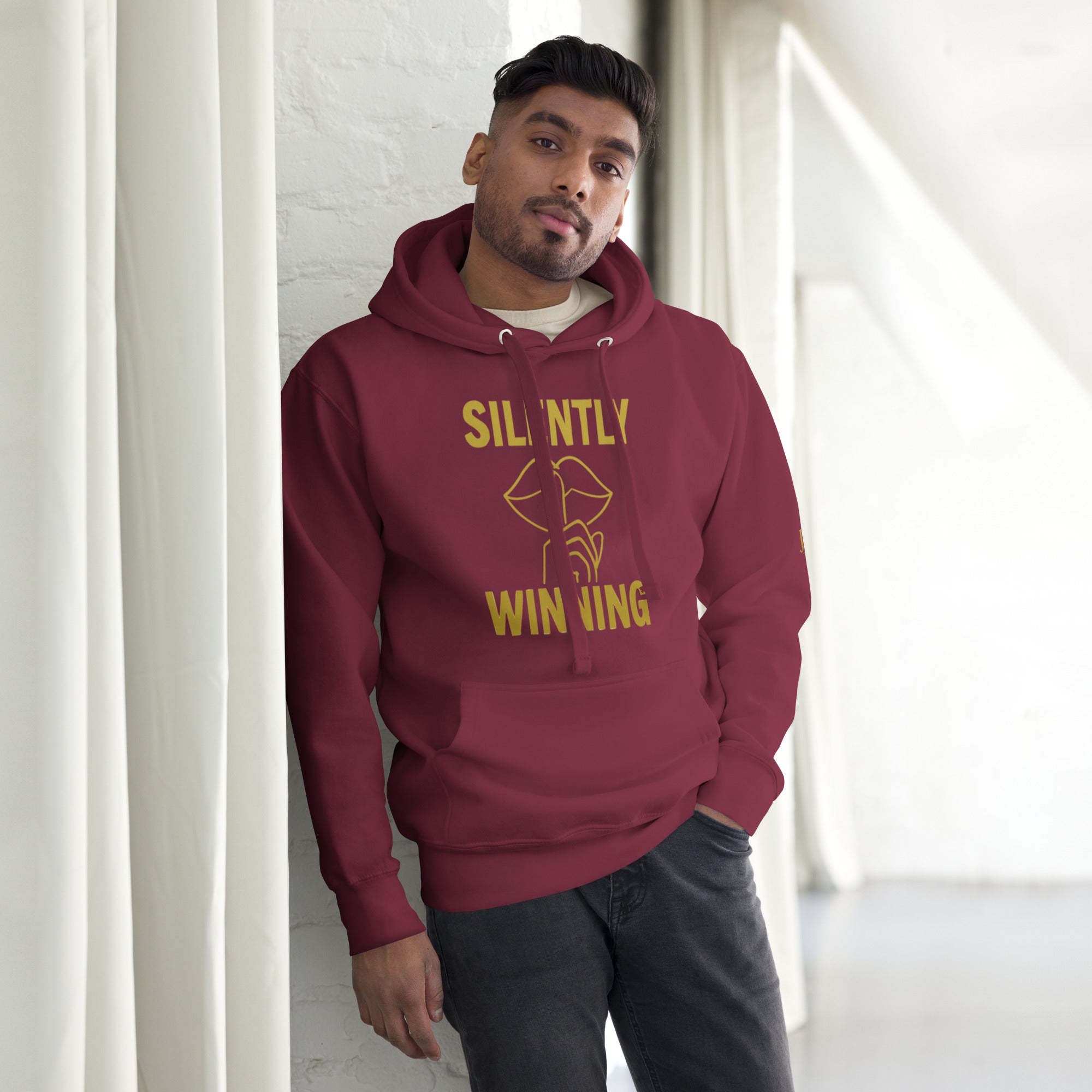 Maroon Silently Winning Hoodie, faith-based luxury apparel with bold lettering, designed for everyday confidence.