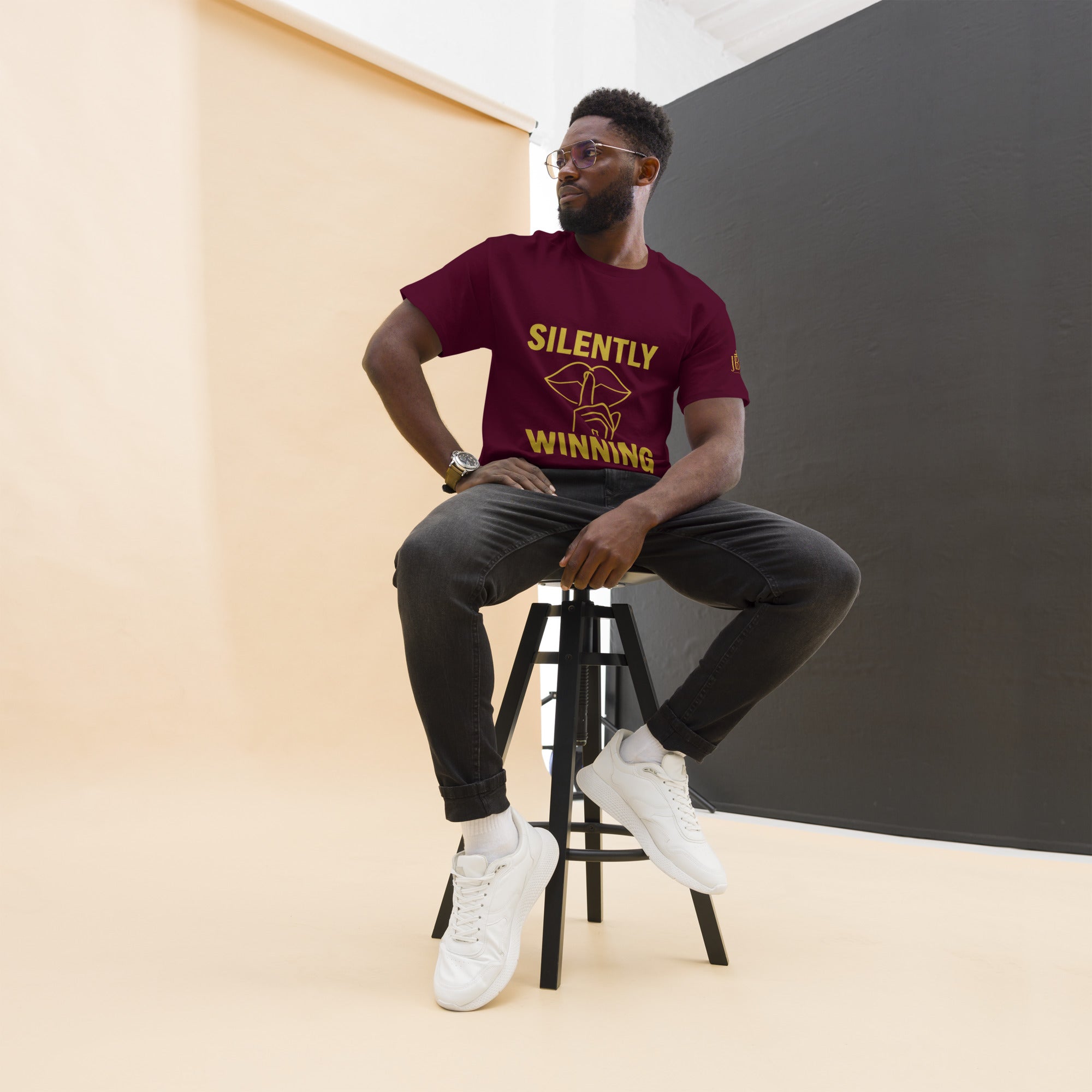 Maroon Silently Winning t-shirt with gold front design. Luxury unisex Christian apparel representing faith, resilience, and victory.