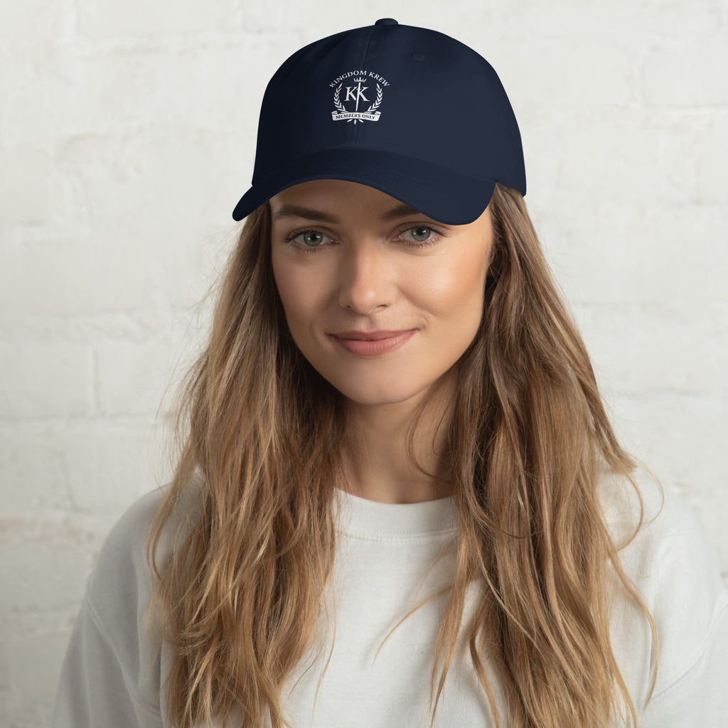 Model in Navy blue dad hat featuring printed Kingdom Krew logo, lightweight unisex fit with strap back closure.