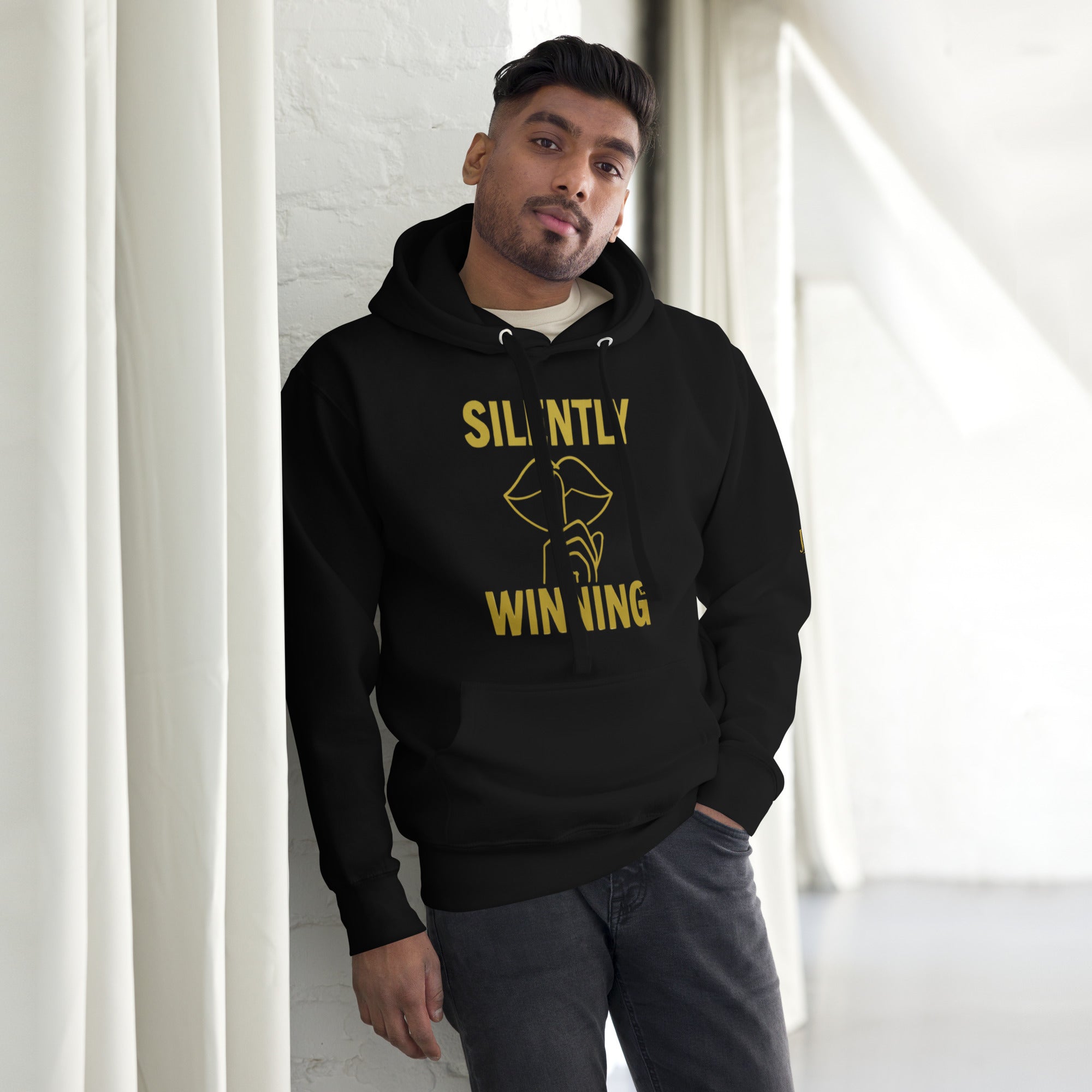 Model wearing Black Silently Winning Hoodie, sleek luxury streetwear with faith-driven message, unisex premium fit.