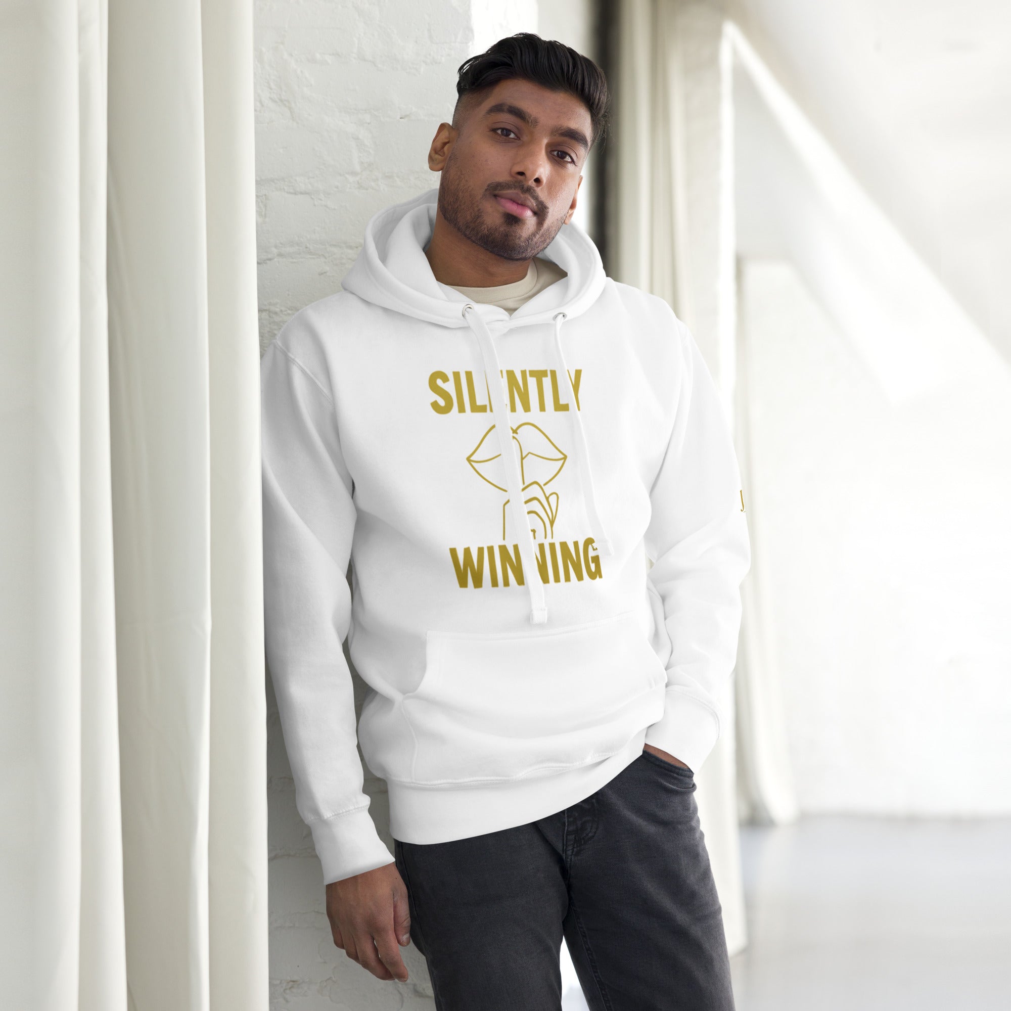 Model wearing the Silently Winning Hoodie in white, luxury streetwear design with bold faith-inspired lettering.