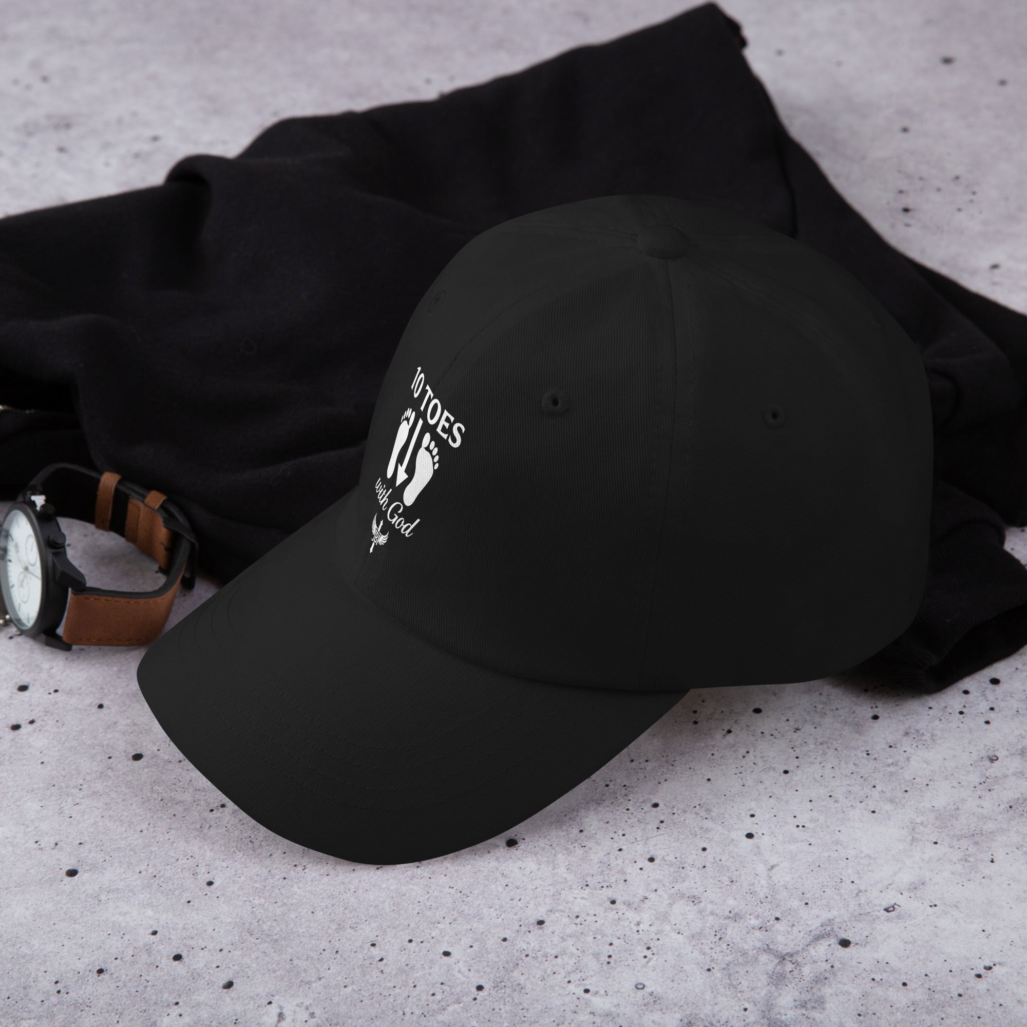 "Side view of black baseball cap showing the 10 Toes Down emblem and adjustable strap."