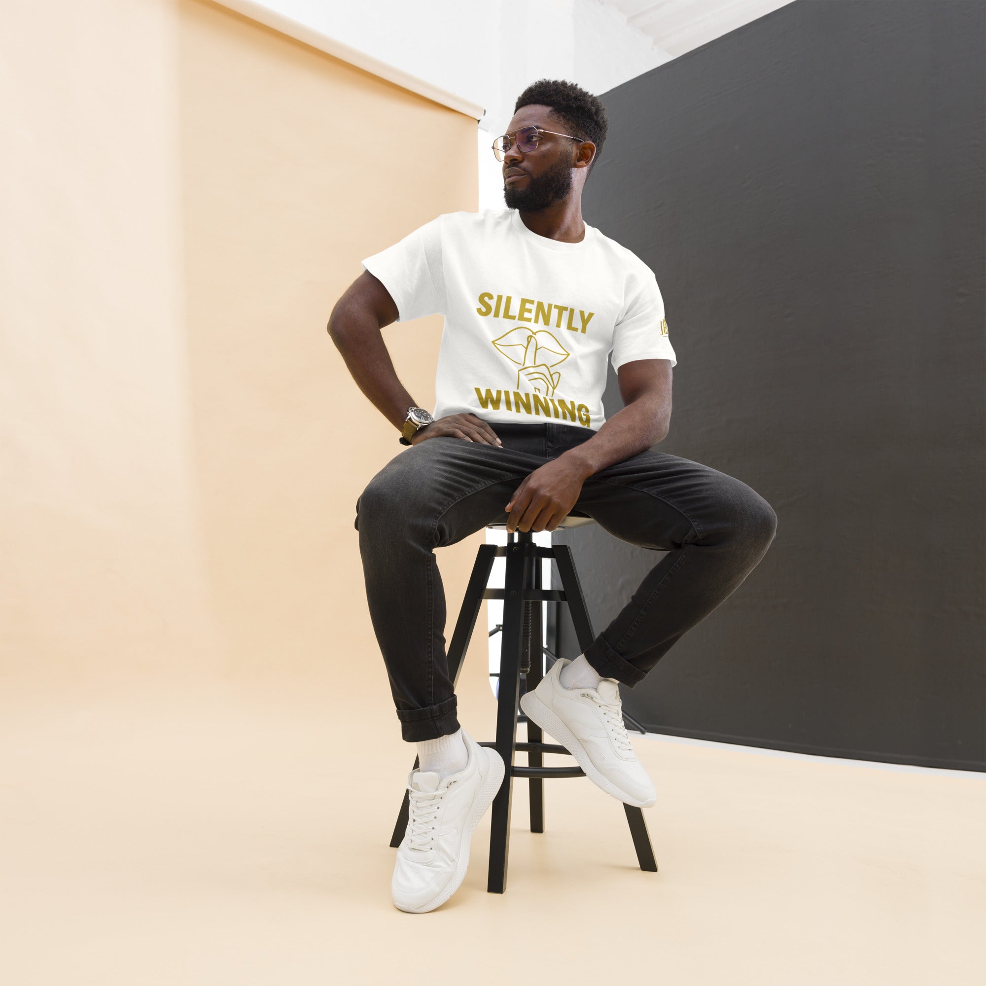 White Silently Winning unisex t-shirt featuring gold statement text across chest. Inspirational Christian streetwear for men and women.